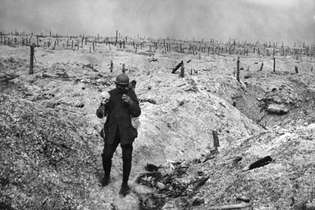 Soldado caminha em meio às trincheiras em campo de batalha na Bélgica