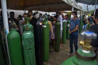 Parentes de pessoas internadas aguardam na fila para comprar cilindros de oxigênio em Manaus