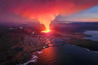 Fumaça ondulante e lava fluindo são vistos nesta imagem do Departamento de Proteção Civil e Gerenciamento de Emergências da Islândia, 14 de janeiro de 2024, durante uma erupção vulcânica nos arredores da cidade evacuada de Grindavik, no oeste da Islândia