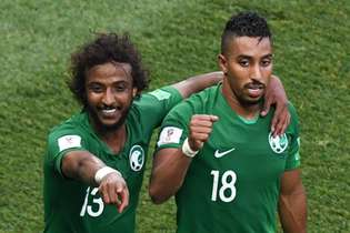 Saudi Arabia's forward Salem Al-Dawsari (R) celebrates with teammate Saudi Arabia's defender Yasser Al-Shahrani, after scoring his team's winning goal during the Russia 2018 World Cup Group A football match between Saudi Arabia and Egypt at the Volgograd Arena in Volgograd on June 25, 2018. / AFP PHOTO / Mark RALSTON / RESTRICTED TO EDITORIAL USE - NO MOBILE PUSH ALERTS/DOWNLOADS